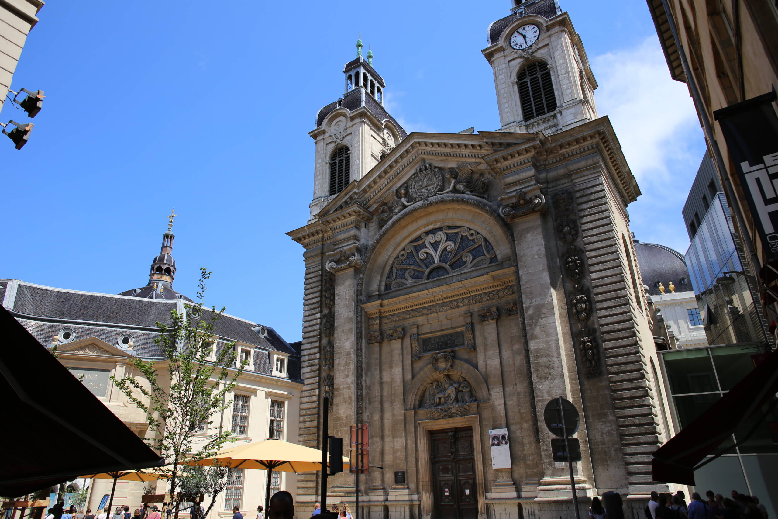 The chapel facade of the Grand Hôtel-Dieu in Lyon, with the clock tower above and Soufflot’s dome visible behind