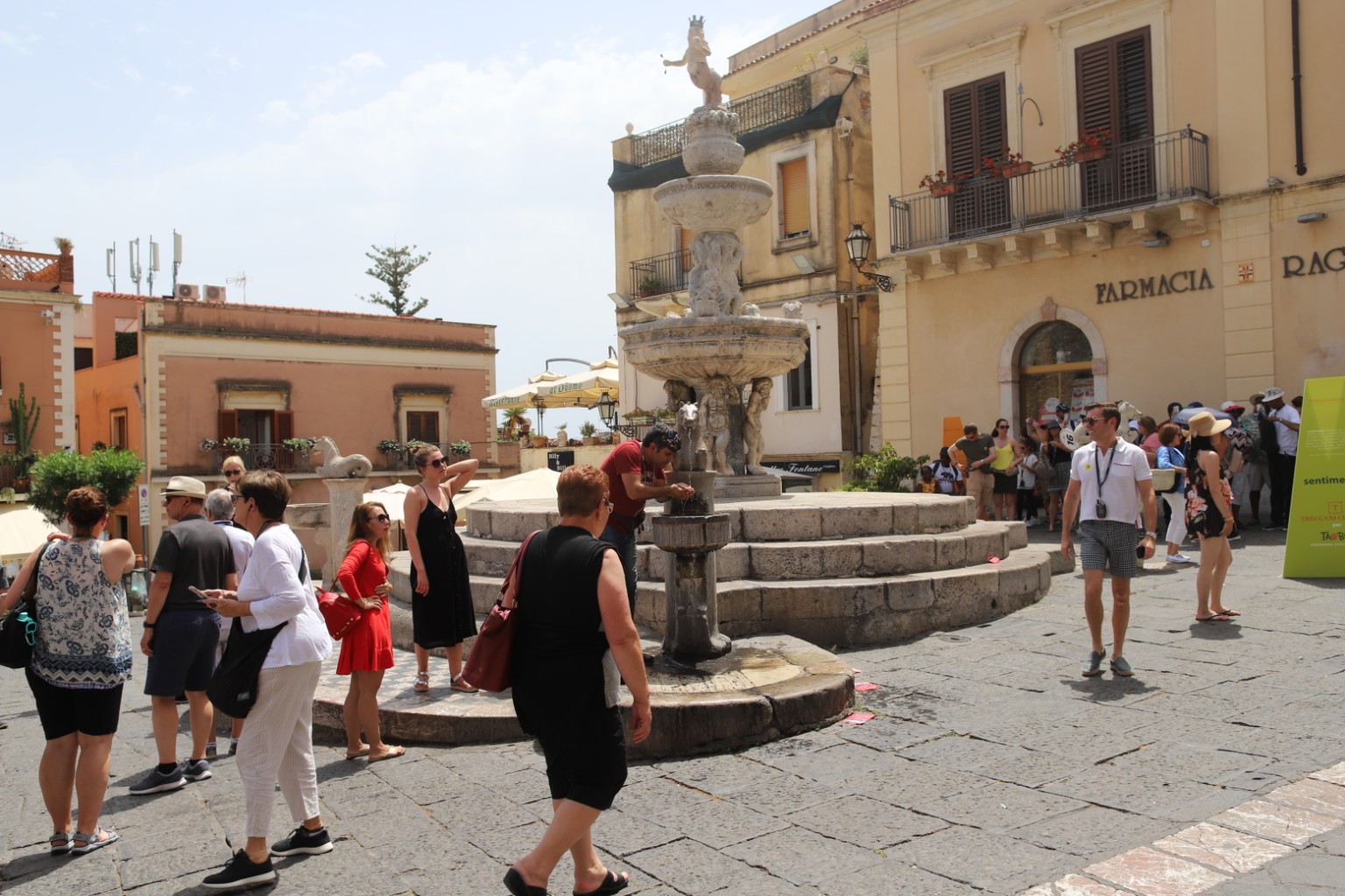 Visitors around the historic fountain in Taormina's Piazza Duomo